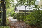 Cozy house with a fireplace in a holiday park in a natural area